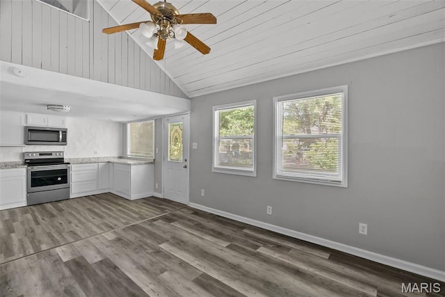 2826 Dawnview Dr, Florissant, MO 63031 - kitchen with stainless steel appliances, vaulted ceiling, wood finished floors, white cabinets, and ceiling fan