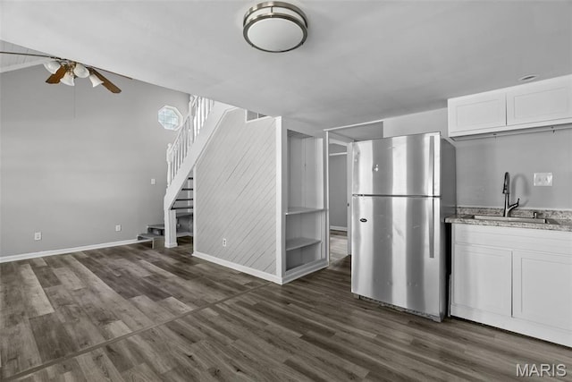2826 Dawnview Dr, Florissant, MO 63031 - kitchen with freestanding refrigerator, a ceiling fan, dark wood-style floors, white cabinetry, and light stone countertops