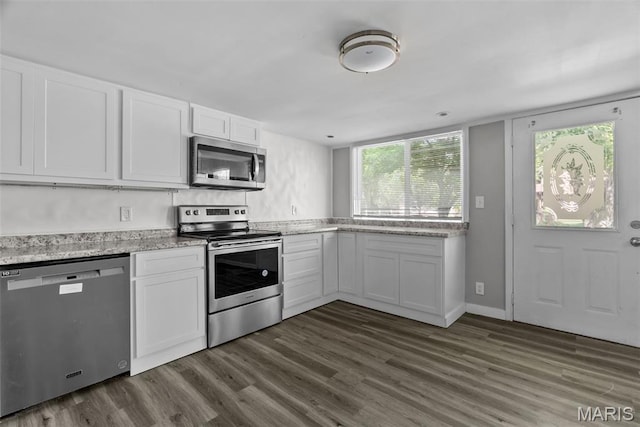 2826 Dawnview Dr, Florissant, MO 63031 - kitchen featuring appliances with stainless steel finishes, dark wood-style floors, and white cabinets