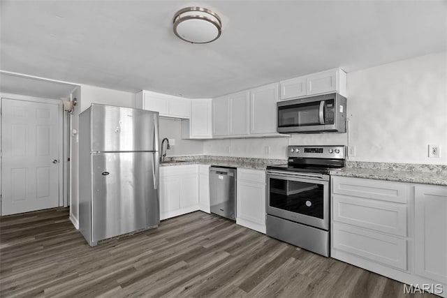 2826 Dawnview Dr, Florissant, MO 63031 - kitchen with appliances with stainless steel finishes, white cabinets, dark wood-style floors, and light stone countertops