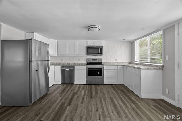2826 Dawnview Dr, Florissant, MO 63031 - kitchen with stainless steel appliances, dark wood-style flooring, white cabinets, and light stone countertops