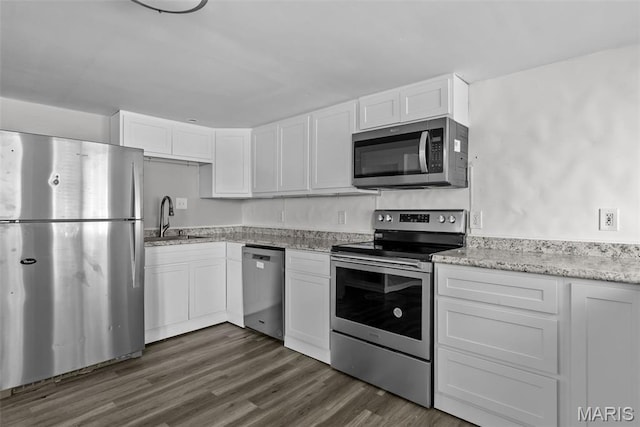 2826 Dawnview Dr, Florissant, MO 63031 - kitchen with stainless steel appliances, white cabinets, light stone countertops, and dark wood finished floors