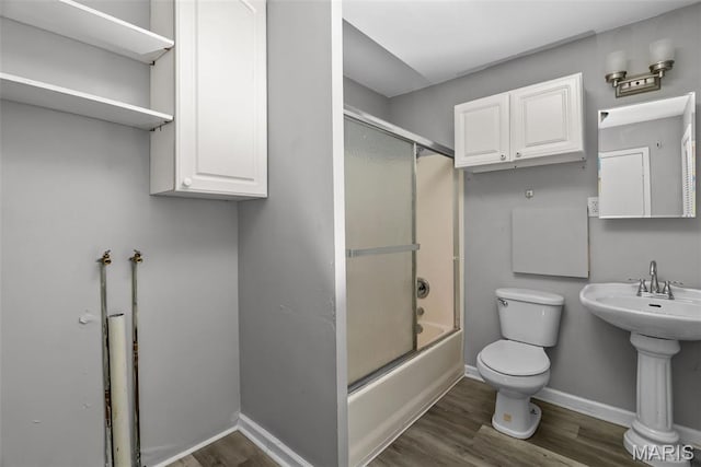 2826 Dawnview Dr, Florissant, MO 63031 - bathroom with wood finished floors and bath / shower combo with glass door