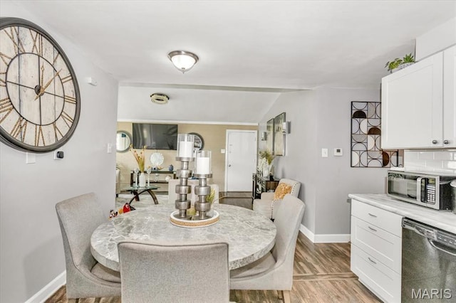 8400 Chalons Ct, Berkeley, MO 63134 - dining space with light wood finished floors and vaulted ceiling