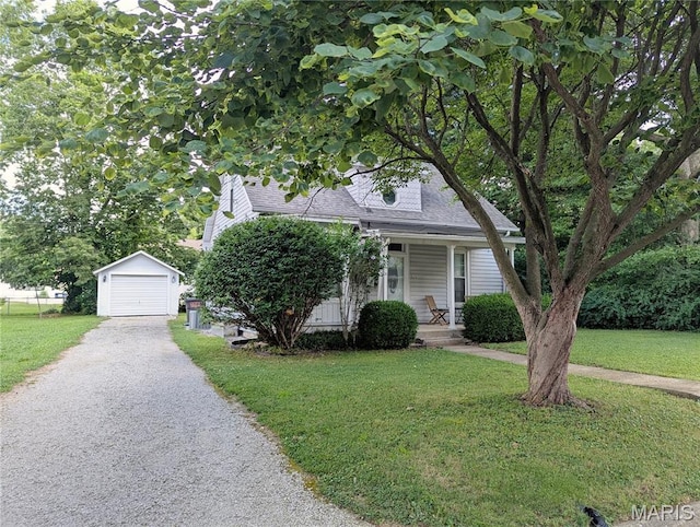 515 E S Ave, Greenville, IL 62246 - view of property hidden behind natural elements featuring an outdoor structure, covered porch, a front lawn, a garage, and asphalt driveway