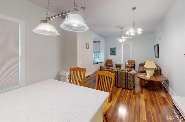 515 E S Ave, Greenville, IL 62246 - dining space with wood finished floors, a ceiling fan, and a chandelier