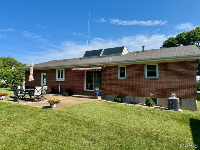 8 E 11th St, Washington, MO 63090 - back of house with a patio, brick siding, and a lawn