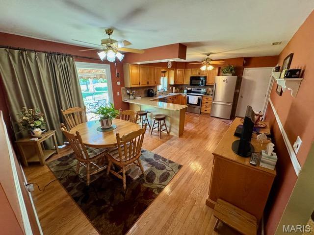 8 E 11th St, Washington, MO 63090 - dining area featuring a ceiling fan and light wood-type flooring