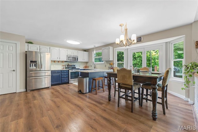 600 Emerald Meadows Ct, Saint Charles, MO 63304 - dining space featuring a chandelier and dark wood finished floors