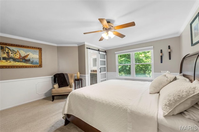 600 Emerald Meadows Ct, Saint Charles, MO 63304 - bedroom with a barn door, a wainscoted wall, ornamental molding, light colored carpet, and a ceiling fan