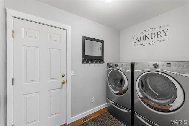 600 Emerald Meadows Ct, Saint Charles, MO 63304 - washroom with washing machine and clothes dryer and dark wood finished floors