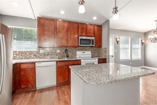 1409 Castle Mill Dr, Arnold, MO 63010 - kitchen featuring stainless steel appliances, light wood-type flooring, brown cabinets, backsplash, and recessed lighting