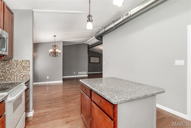 1409 Castle Mill Dr, Arnold, MO 63010 - kitchen with white range with electric stovetop, light wood-type flooring, backsplash, a center island, and a chandelier