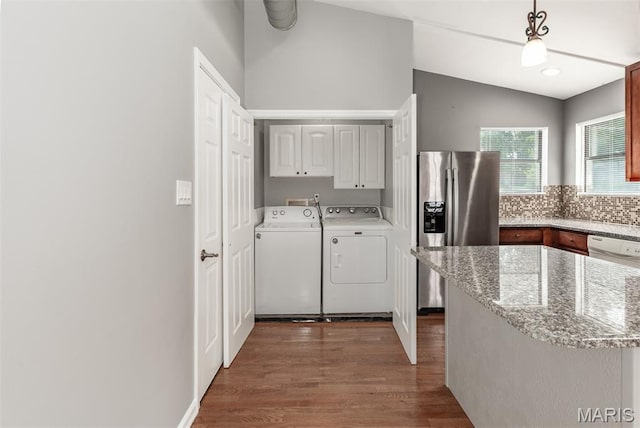 1409 Castle Mill Dr, Arnold, MO 63010 - washroom featuring separate washer and dryer, cabinet space, and dark wood-style flooring