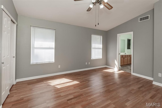 1409 Castle Mill Dr, Arnold, MO 63010 - unfurnished bedroom with vaulted ceiling, light wood finished floors, a closet, connected bathroom, and ceiling fan