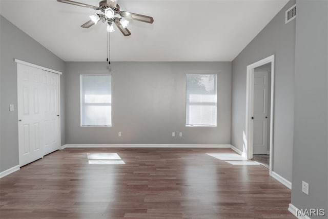 1409 Castle Mill Dr, Arnold, MO 63010 - unfurnished bedroom with wood finished floors, lofted ceiling, ceiling fan, and a closet