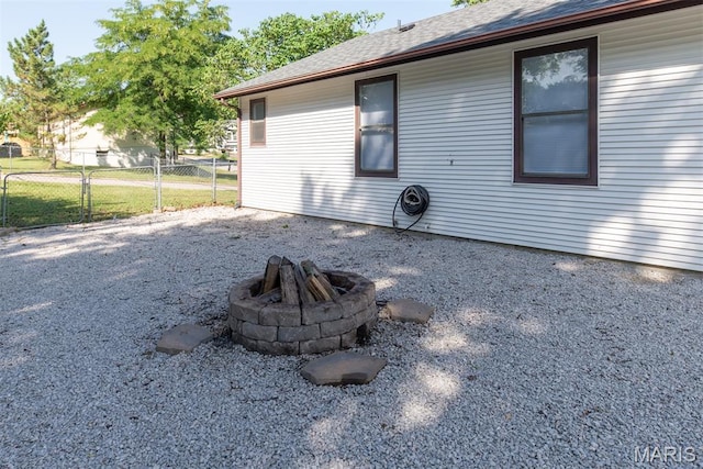 1409 Castle Mill Dr, Arnold, MO 63010 - view of property exterior with a fire pit and a shingled roof