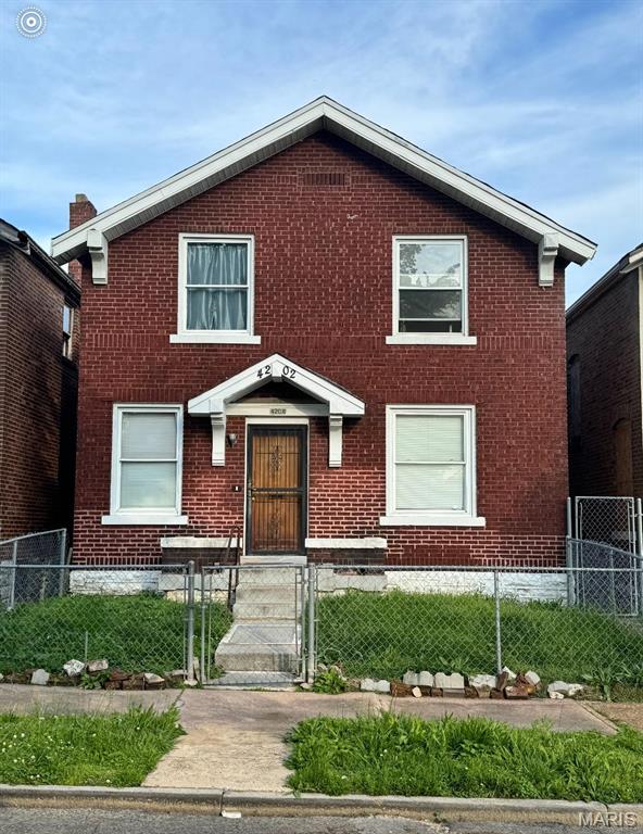 4202 Gano Ave, Saint Louis, MO 63107 - view of front of property with brick siding, a fenced front yard, and a gate