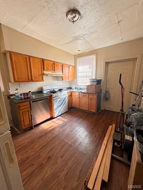 4202 Gano Ave, Saint Louis, MO 63107 - kitchen with white range with gas cooktop, stainless steel dishwasher, under cabinet range hood, dark wood finished floors, and a textured ceiling