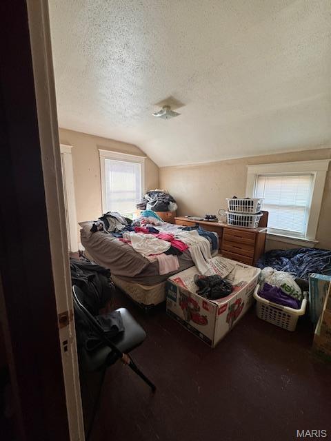 4202 Gano Ave, Saint Louis, MO 63107 - bedroom with a textured ceiling and vaulted ceiling