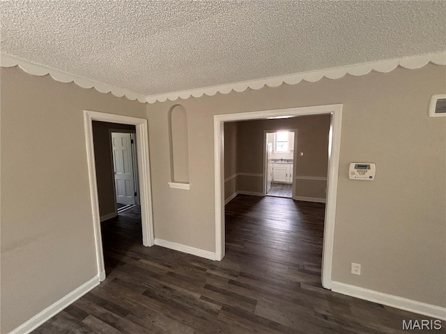 6765 Kenwood Dr, Northwoods, MO 63121 - spare room with a textured ceiling and dark wood finished floors