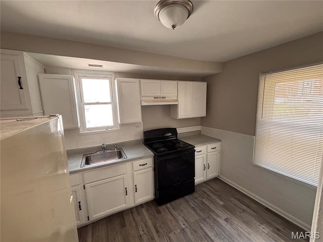 6765 Kenwood Dr, Northwoods, MO 63121 - kitchen featuring black electric range, under cabinet range hood, refrigerator, white cabinets, and a wainscoted wall
