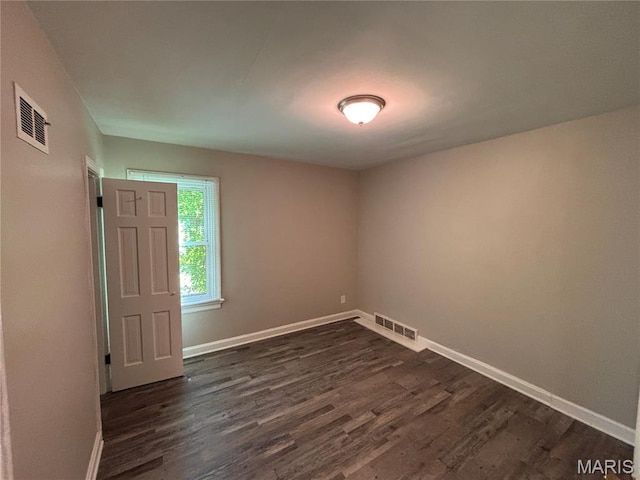 6765 Kenwood Dr, Northwoods, MO 63121 - empty room with dark wood-type flooring