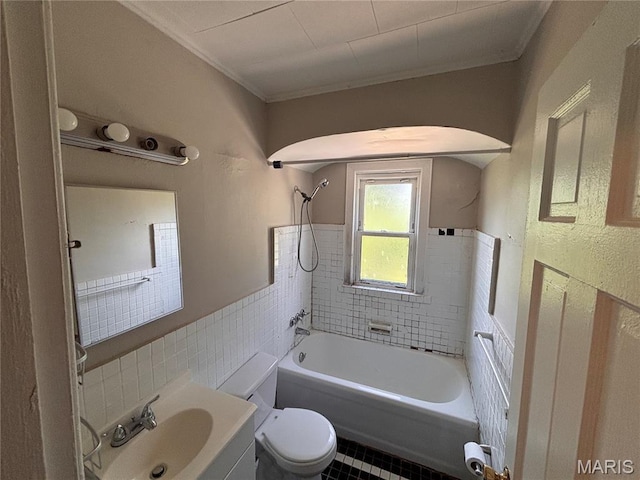 6765 Kenwood Dr, Northwoods, MO 63121 - bathroom featuring tile walls, shower / bath combination, a wainscoted wall, ornamental molding, and tile patterned floors