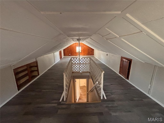 6765 Kenwood Dr, Northwoods, MO 63121 - bonus room with wood finished floors, vaulted ceiling, and wood walls