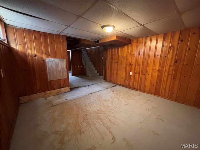 6765 Kenwood Dr, Northwoods, MO 63121 - finished below grade area with stairs, wood walls, and a drop ceiling