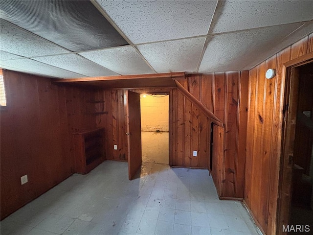 6765 Kenwood Dr, Northwoods, MO 63121 - finished basement featuring wooden walls and light floors