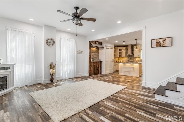712 Maple St, Hillsboro, MO 63050 - living room featuring a ceiling fan, wood finished floors, recessed lighting, stairs, and a fireplace