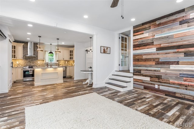 712 Maple St, Hillsboro, MO 63050 - kitchen with cream cabinets, stainless steel appliances, wall chimney range hood, wood finished floors, and recessed lighting
