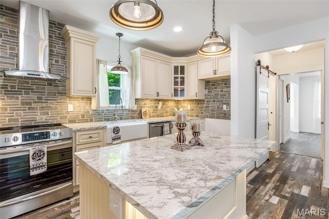 712 Maple St, Hillsboro, MO 63050 - kitchen featuring stainless steel appliances, wall chimney range hood, cream cabinets, light stone counters, and decorative backsplash