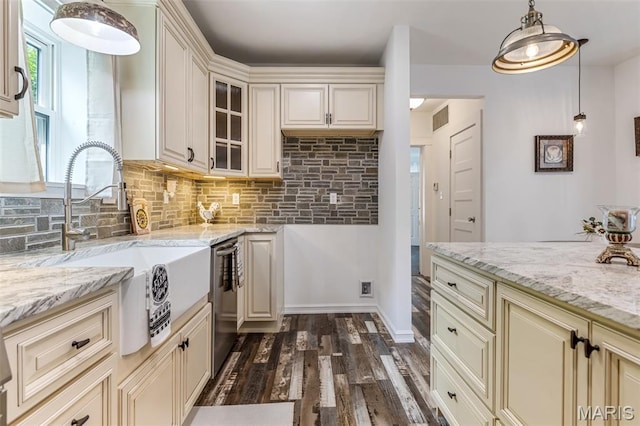 712 Maple St, Hillsboro, MO 63050 - kitchen with cream cabinetry, stainless steel dishwasher, dark wood finished floors, decorative backsplash, and light stone counters