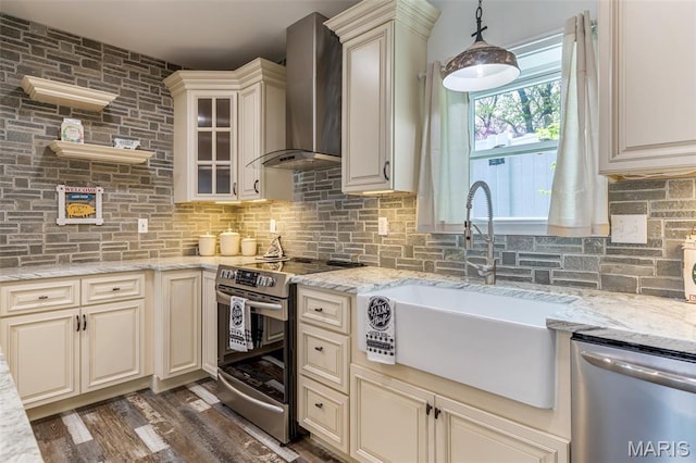 712 Maple St, Hillsboro, MO 63050 - kitchen with stainless steel appliances, wall chimney range hood, cream cabinetry, backsplash, and light stone countertops
