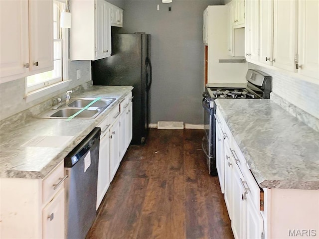 112 W Thurman St, Columbia, MO 65202 - kitchen featuring appliances with stainless steel finishes, dark wood-style floors, tasteful backsplash, light countertops, and white cabinetry