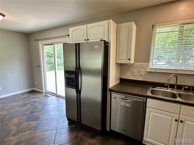 7 Oxbow Rd, Saint Peters, MO 63376 - kitchen with appliances with stainless steel finishes, dark countertops, white cabinetry, and tasteful backsplash