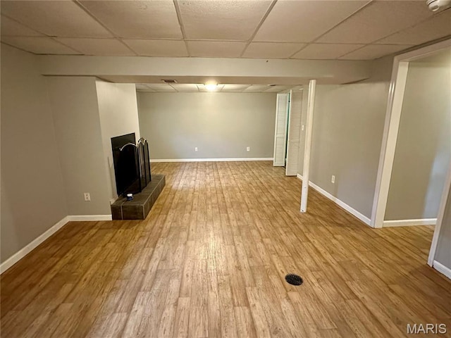 7 Oxbow Rd, Saint Peters, MO 63376 - unfurnished living room featuring a paneled ceiling, a fireplace with raised hearth, and wood finished floors