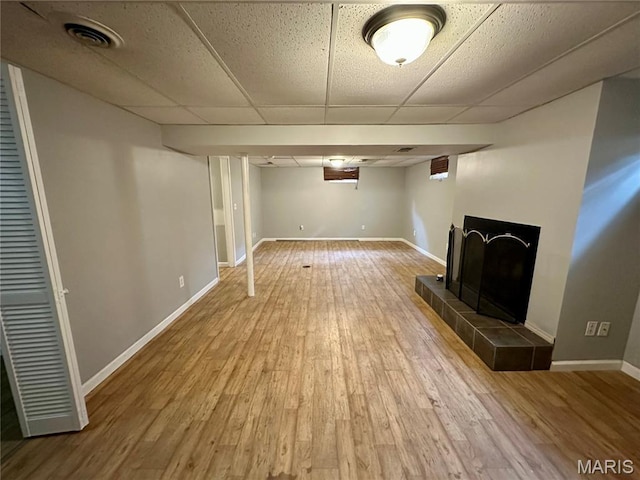 7 Oxbow Rd, Saint Peters, MO 63376 - finished basement with a tiled fireplace, wood finished floors, and a paneled ceiling