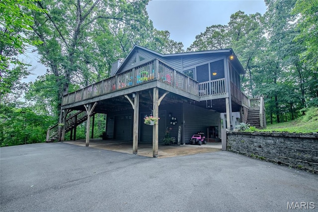 532 Fairfield Valley Rd, Pacific, MO 63069 - view of front facade with stairway, asphalt driveway, a deck, and a sunroom
