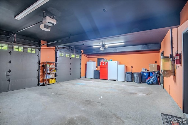 532 Fairfield Valley Rd, Pacific, MO 63069 - garage featuring white fridge, freestanding refrigerator, and a garage door opener