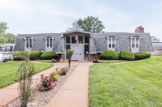 1675 Blue Ridge Dr Unit B, Lemay Township, MO 63125 - view of property featuring mansard roof, brick siding, a front yard, and a chimney