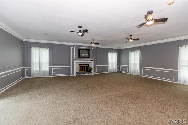1675 Blue Ridge Dr Unit B, Lemay Township, MO 63125 - unfurnished living room with a decorative wall, crown molding, carpet floors, a ceiling fan, and a glass covered fireplace