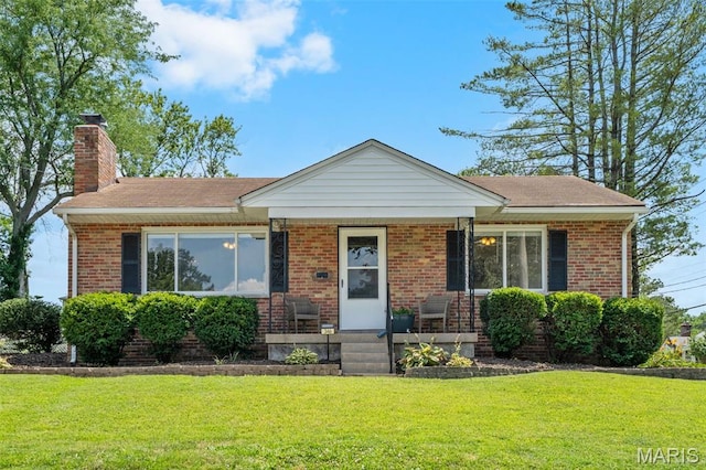 346 Madison Ave, Saint Louis, MO 63119 - view of front of home with a front lawn, brick siding, a chimney, and a porch