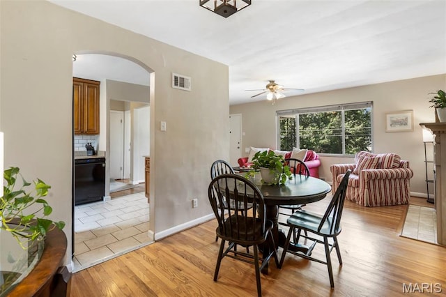 346 Madison Ave, Saint Louis, MO 63119 - dining space with arched walkways, ceiling fan, and light wood-style flooring
