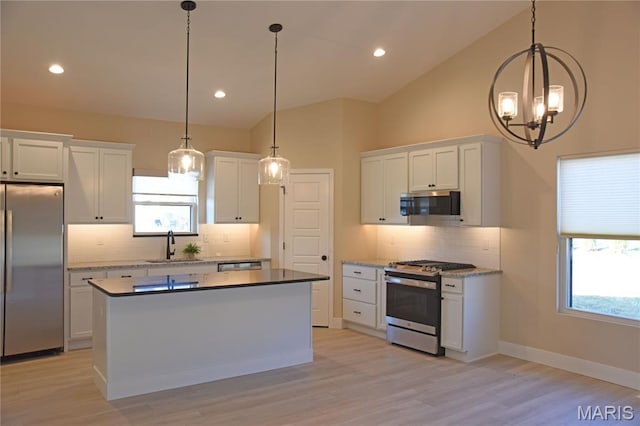 8748 Wendell Creek Dr, Saint Jacob, IL 62281 - kitchen featuring stainless steel appliances, backsplash, white cabinets, plenty of natural light, and lofted ceiling