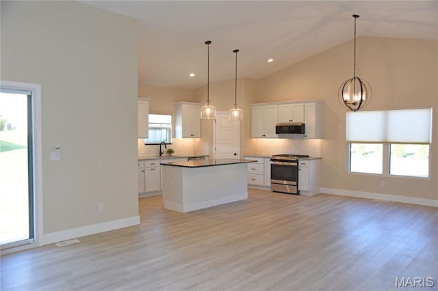 8748 Wendell Creek Dr, Saint Jacob, IL 62281 - kitchen with appliances with stainless steel finishes, tasteful backsplash, a chandelier, white cabinets, and high vaulted ceiling