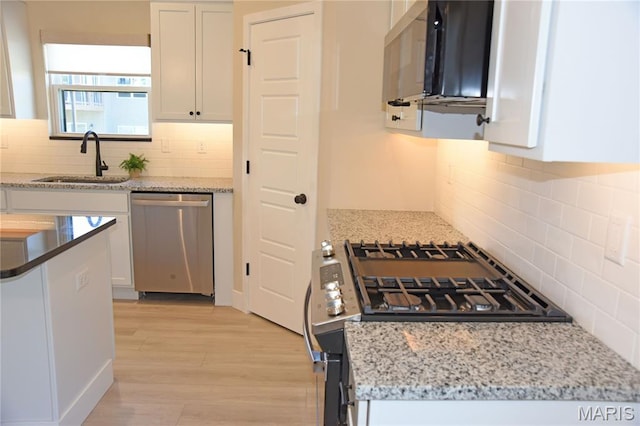 8748 Wendell Creek Dr, Saint Jacob, IL 62281 - kitchen featuring appliances with stainless steel finishes, white cabinetry, decorative backsplash, light wood finished floors, and healthy amount of natural light