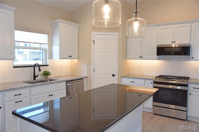 8748 Wendell Creek Dr, Saint Jacob, IL 62281 - kitchen featuring stainless steel appliances, white cabinetry, tasteful backsplash, and decorative light fixtures